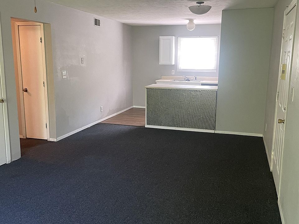 Nice open living area with updated carpet, metal accent on from kitchen bar area, updated paint colo
