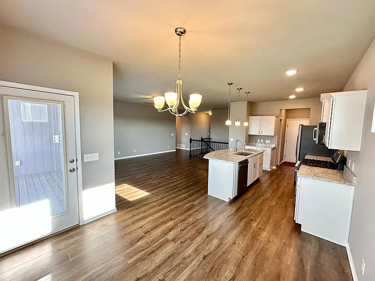 Open concept kitchen and living room, viewed from dining area