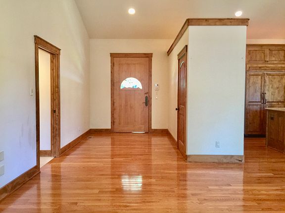The entry way through the bear cub carved door. Coat closet on the right.