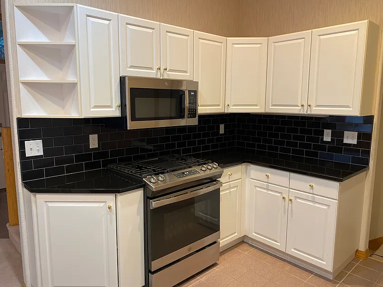 kitchen with gas range, new granite and backsplash. Pantry and plenty of storage. Dumbwaiter from garage