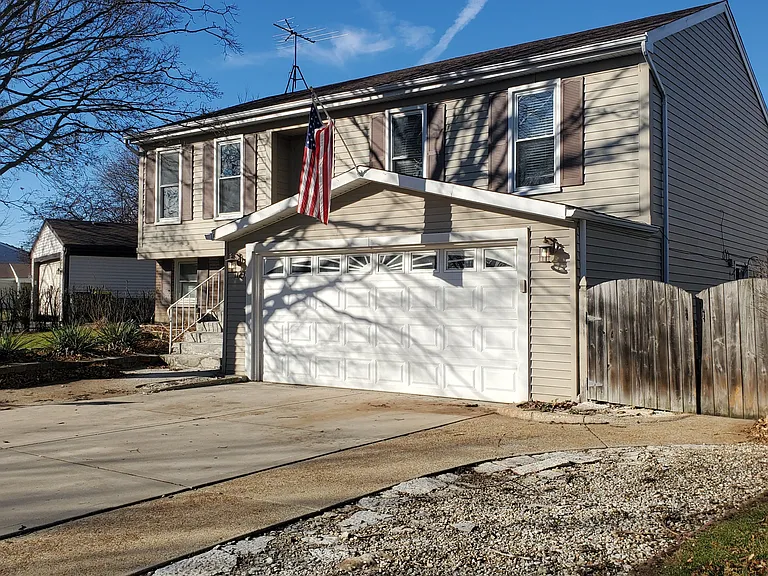 Front of home showing 3 car wide driveway