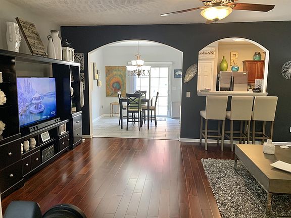 A wide arched door way that opens the kitchen and dining area to the large living space on the main floor