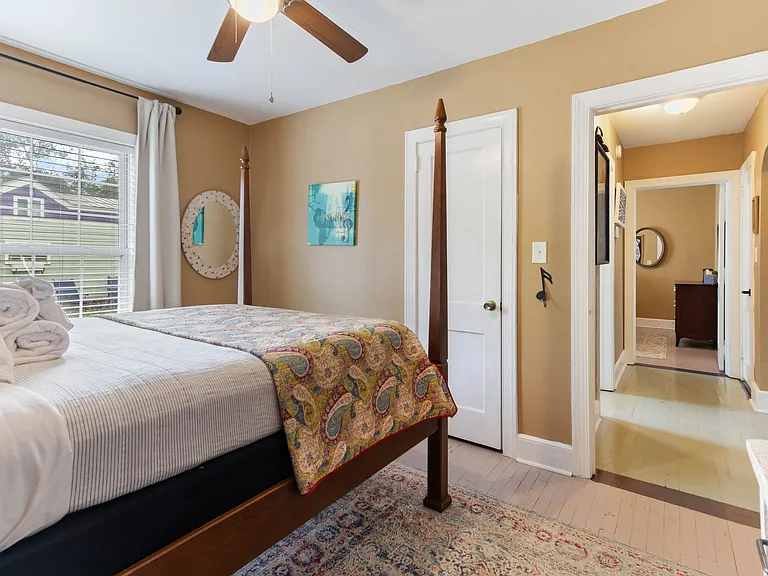 Larson's Room at Hunsucker's Place features a plush memory foam bed, warm decor, and natural light. Conveniently located near Downtown Greensboro and Cone Health Hospital, this cozy space provides comfort and charm in a beautifully central home.
