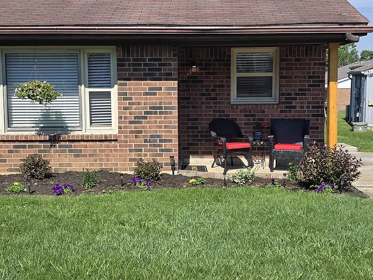 Right side of duplex; small patio to enjoy an evening libation. New landscaping (soaker hose watering) with room to add your own plants (herbs, vegies, flowers).