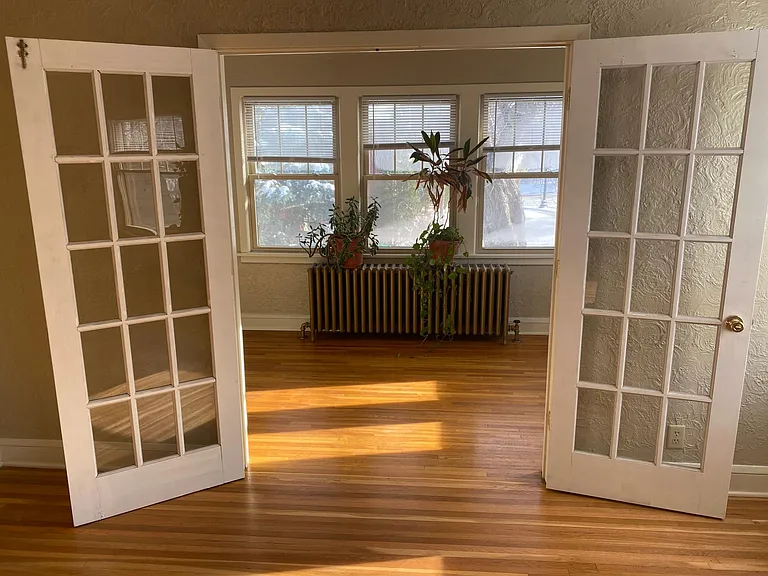 Living room with doors open into sunroom.