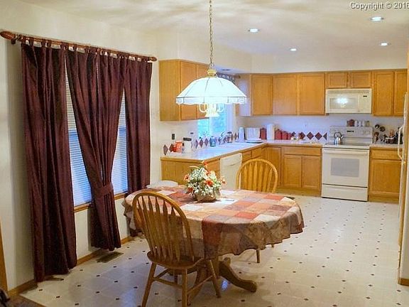 The large kitchen has tons of counter and cabinet space, and overlooks the spect