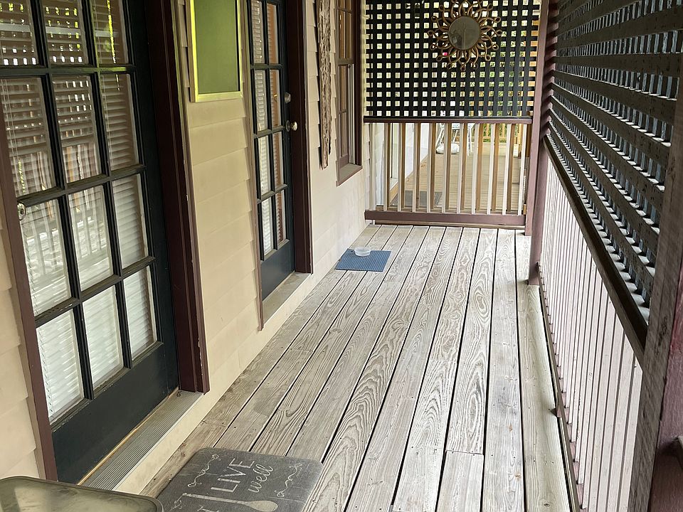 Private 2nd floor covered deck. Door on left enters living room. Door on right enters bedroom.