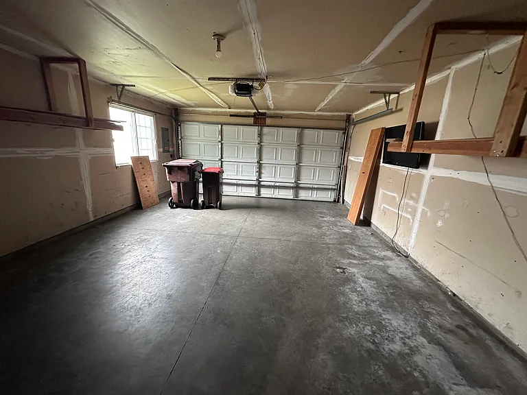 Deep two-car garage with overhead storage framing