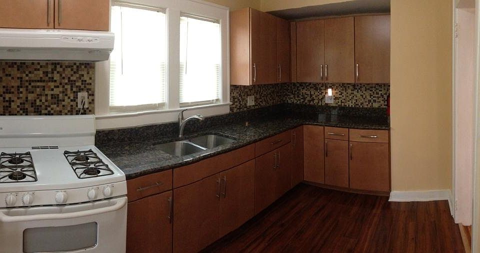 Large Eat-In Kitchen with Granite counters and tile backspla