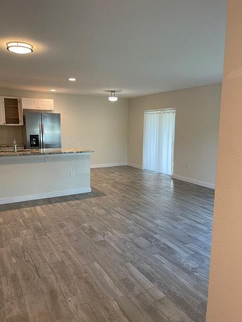 View from front door. Living and dining area with slider to a screened in porch.