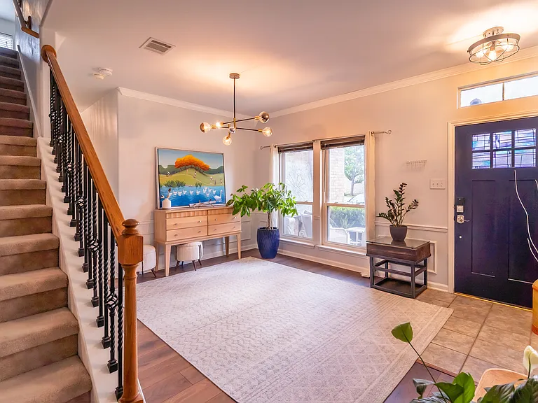 Bright & Airy Foyer: Step inside to a spacious, light-filled entryway that immediately feels like home. Featuring stylish modern lighting, beautiful flooring, and a grand staircase, this open foyer offers a fantastic first impression for guests.