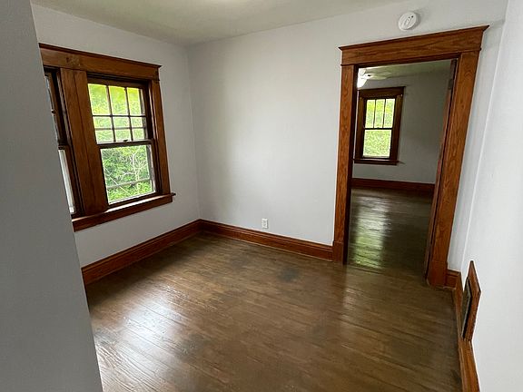 Dining room , original hardwood floors, window, and door frame