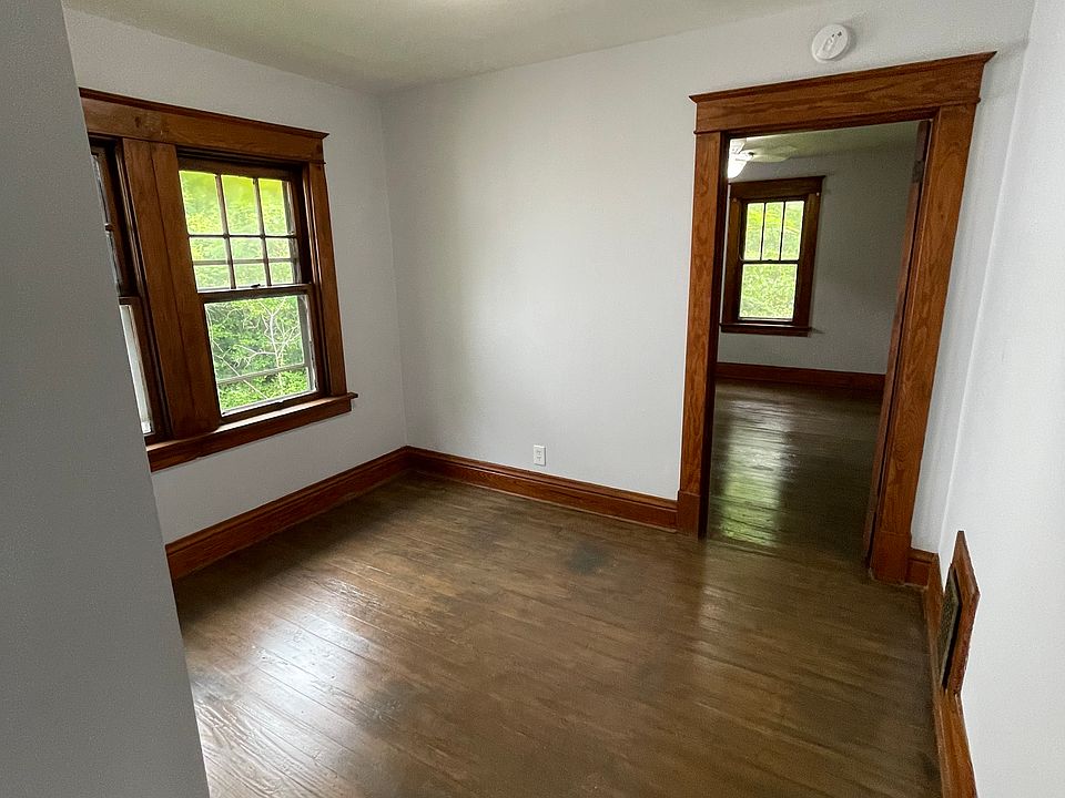 Dining room , original hardwood floors, window, and door frame