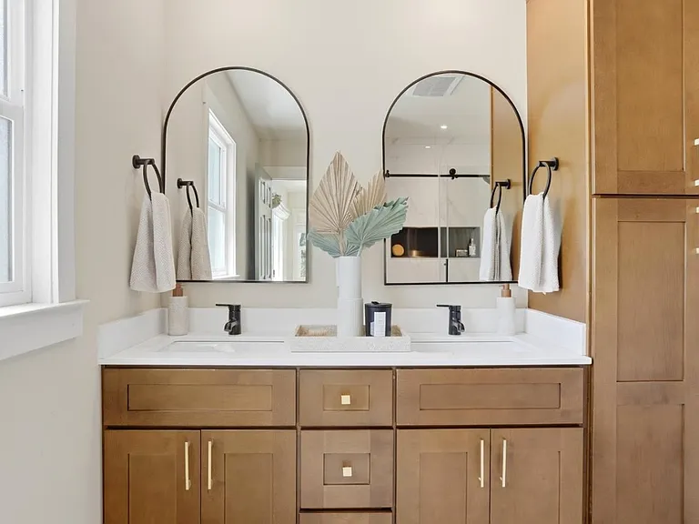 Elegant dual-vanity primary bathroom with custom cabinetry