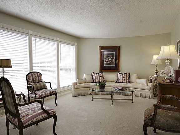 Beautiful living room upon entry is spacious with 3 large windows for an abundance of great natural 