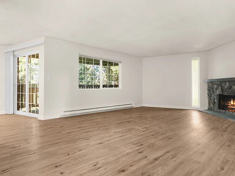 Bright living room with hardwood-style floors and cozy fireplace