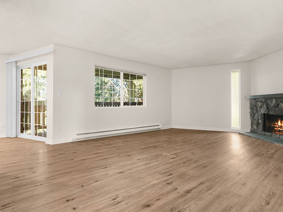 Bright living room with hardwood-style floors and cozy fireplace