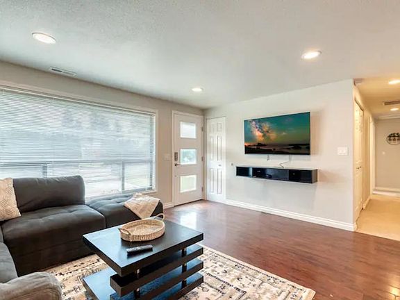 Open & inviting living room with 55" UHD TV w/ Disney + to enjoy with the family