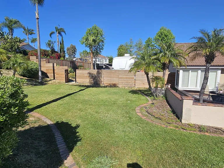 front of house northside photo of new Fence with RV gate and two pedestrian gates