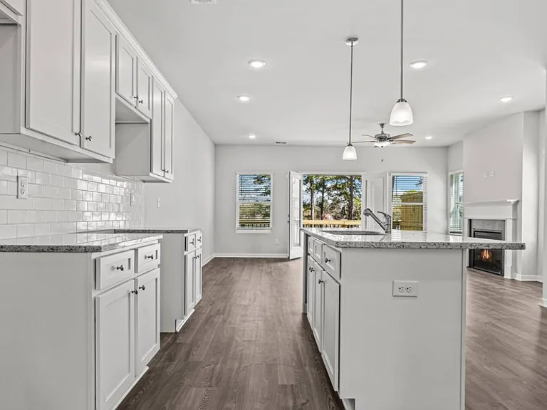 Kitchen with island, granite counters, picture taken before stainless appliances installed (May 2025)