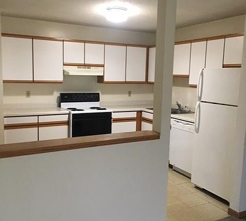 Eat in kitchen with dishwasher, pantry, fridge and electric stove.