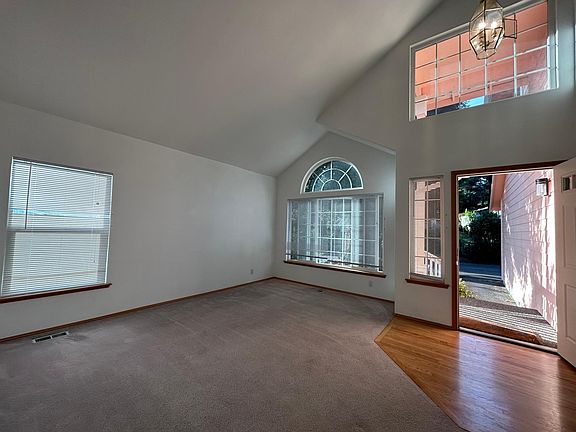 Bright living room with high ceiling and upper deck window