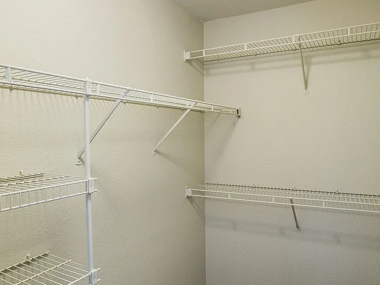 Walk-in closet with built-in shelving.