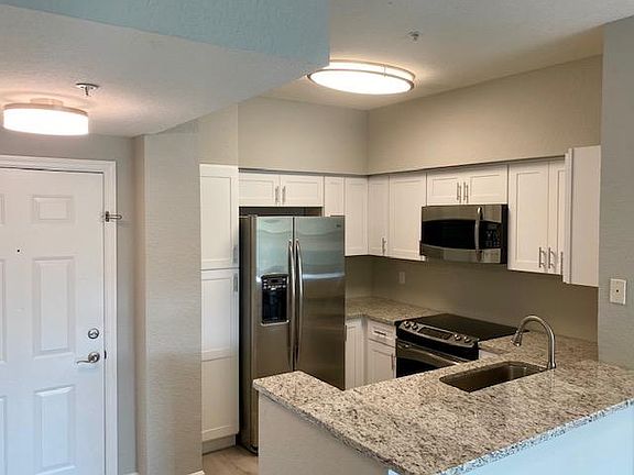 Brand new kitchen with real wood cabinets, soft close doors, stainless steel GE profile appliances including microwave, dishwasher, refrigerator, glass top range, oven, and disposal. Moen fixtures and chrome hardware. Granite countertops with room for bar