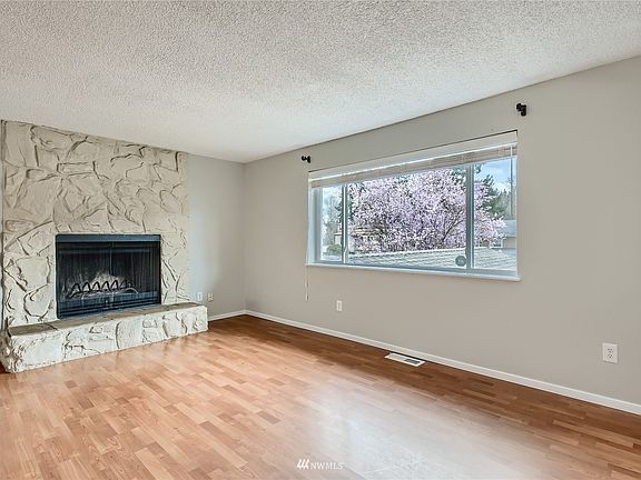 Open spacious living room with wood burning fireplace!