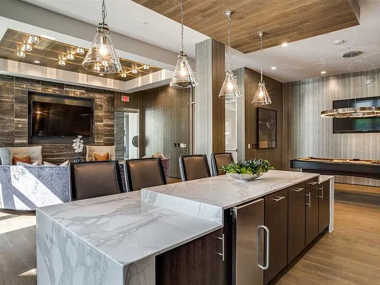 Welcoming community room with pool table and chef's kitchen.