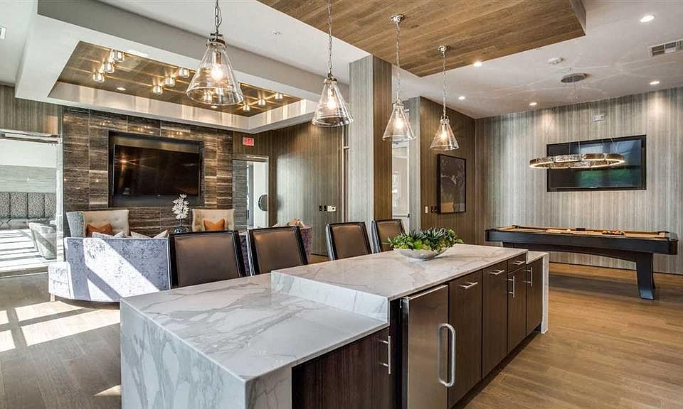 Welcoming community room with pool table and chef's kitchen.