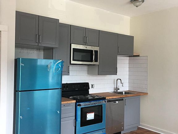Beautiful, fully renovated kitchens with stainless steel appliances. The blue is only a protective covering as they are brand new.