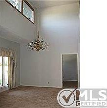 Two story dining room with picture window.