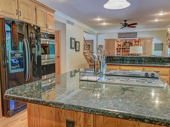 Gorgeous!!!  Large granite top island, the appliances just sparkle!  Enjoy your family and friends here, at the heart of the home, opens up to the sunroom and big deck.