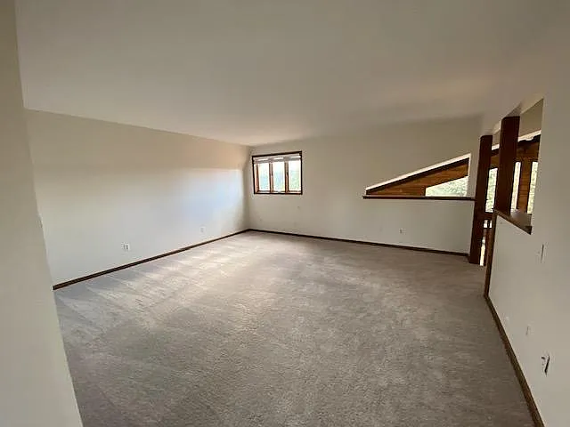 Large primary suite with view of backyard. New French doors and glass installed since the timing of this photo to enclose the room.
