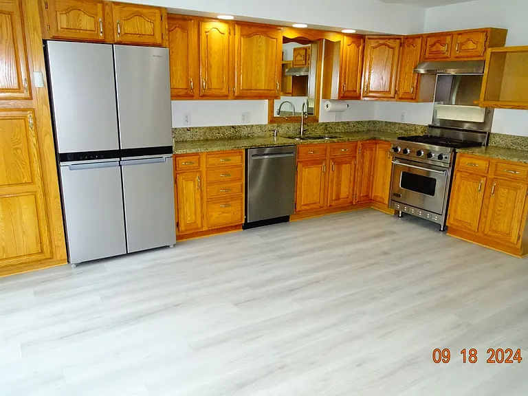 Updated Kitchen with stainless appliances and a Viking Gas cook range and new vinyl plank floors