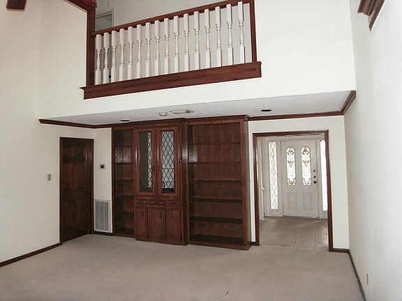 ANOTHER VIEW OF DEN LOOKING BACK TOWARD FRONT DOOR