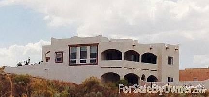 Rear
						:
						Also taken from road, lower level has covered patio and garage