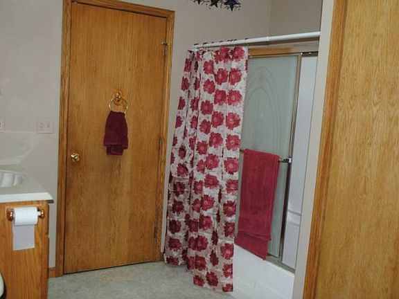 The bathroom is very clean and neat. The doors to the right is the laundry area.