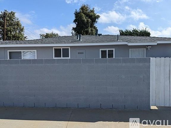 Side patio that is enclosed with a concrete block wall for privacy.