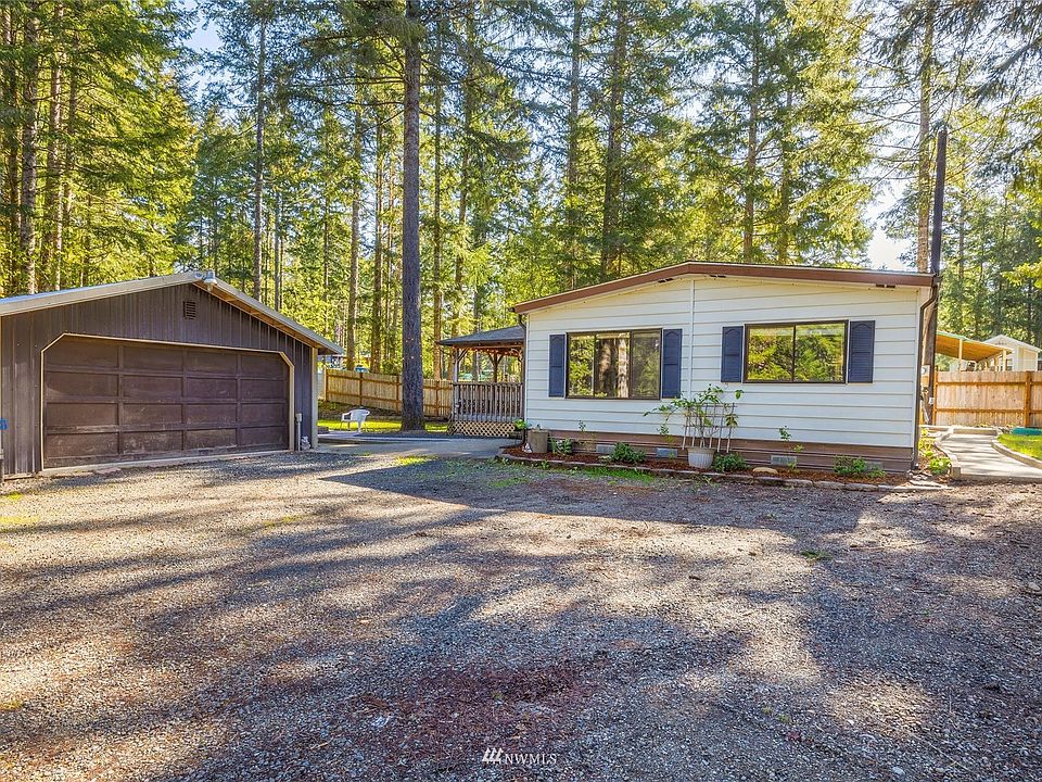 Welcome to your two-bedroom home at the end of the cul-de-sac in Beautiful Maggie Lake! Side of home showing a partial view of your oversized two car garage/shop. You have plenty of room for parking your vehicles and RV.