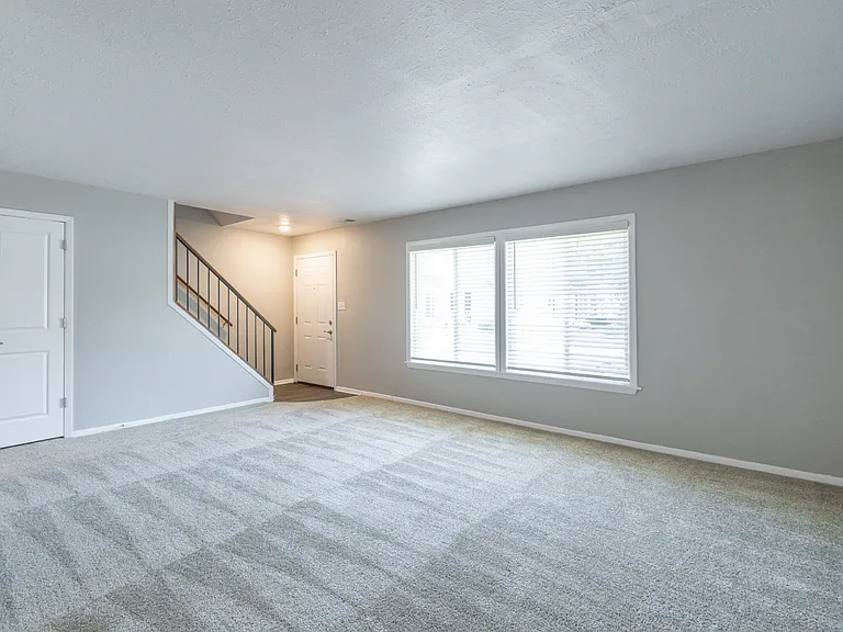Living Room in the Three Bedroom Townhome at Woodbridge Bloomington