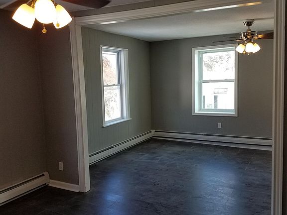 Living room and dining room. New floors, paint, and lighting