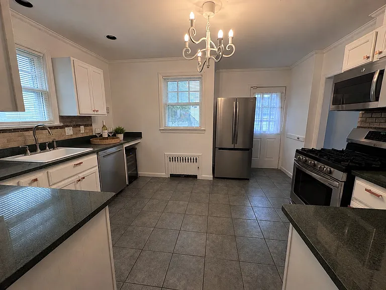 Updated spacious kitchen with access to back deck