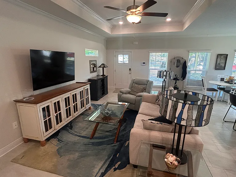 Great room TV area cabinet for storage and comfortable sofa and recliner