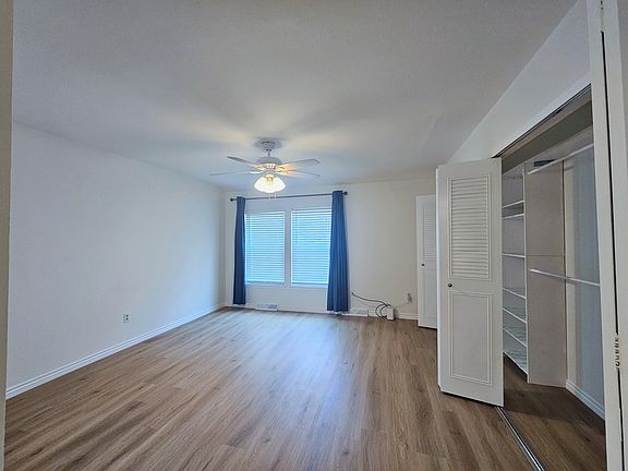 Master Bedroom Suite with spacious closets, fan, and blackout curtains
