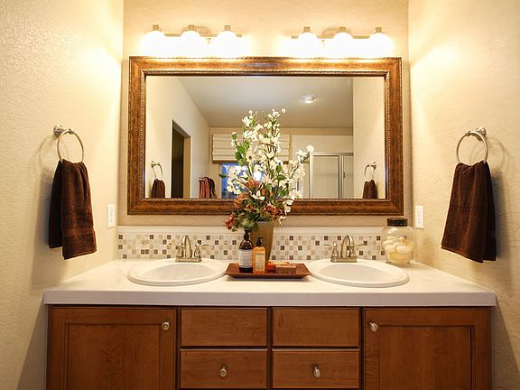 Raised vanity with double sinks and Delta faucets