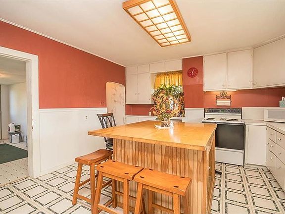 Quaint kitchen with big island.