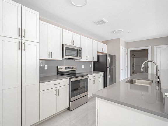 Large functional kitchen with plenty of cabinets and stainless steel appliances
