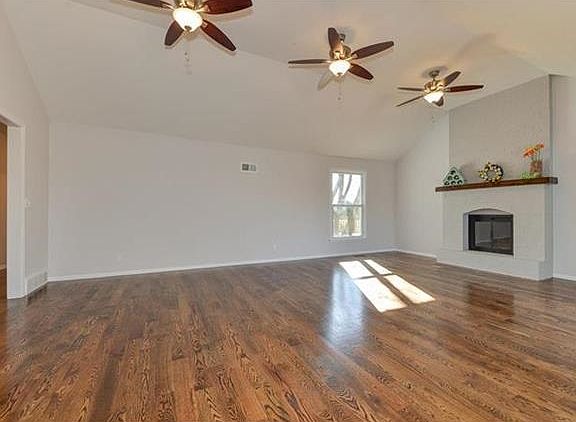 ENTER YOUR HOME TO SEE LARGE LIVING ROOM WITH NEW BEAUTIFUL WOOD FLOORS